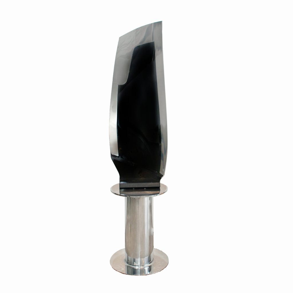 Boeing 777 General Electric GE90 jet engine blade mounted to a rotating polished base.