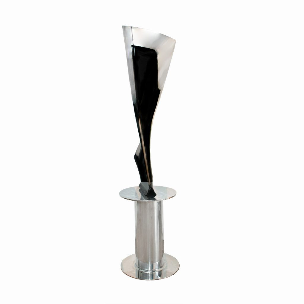 Boeing 777 General Electric GE90 jet engine blade mounted to a rotating polished base.