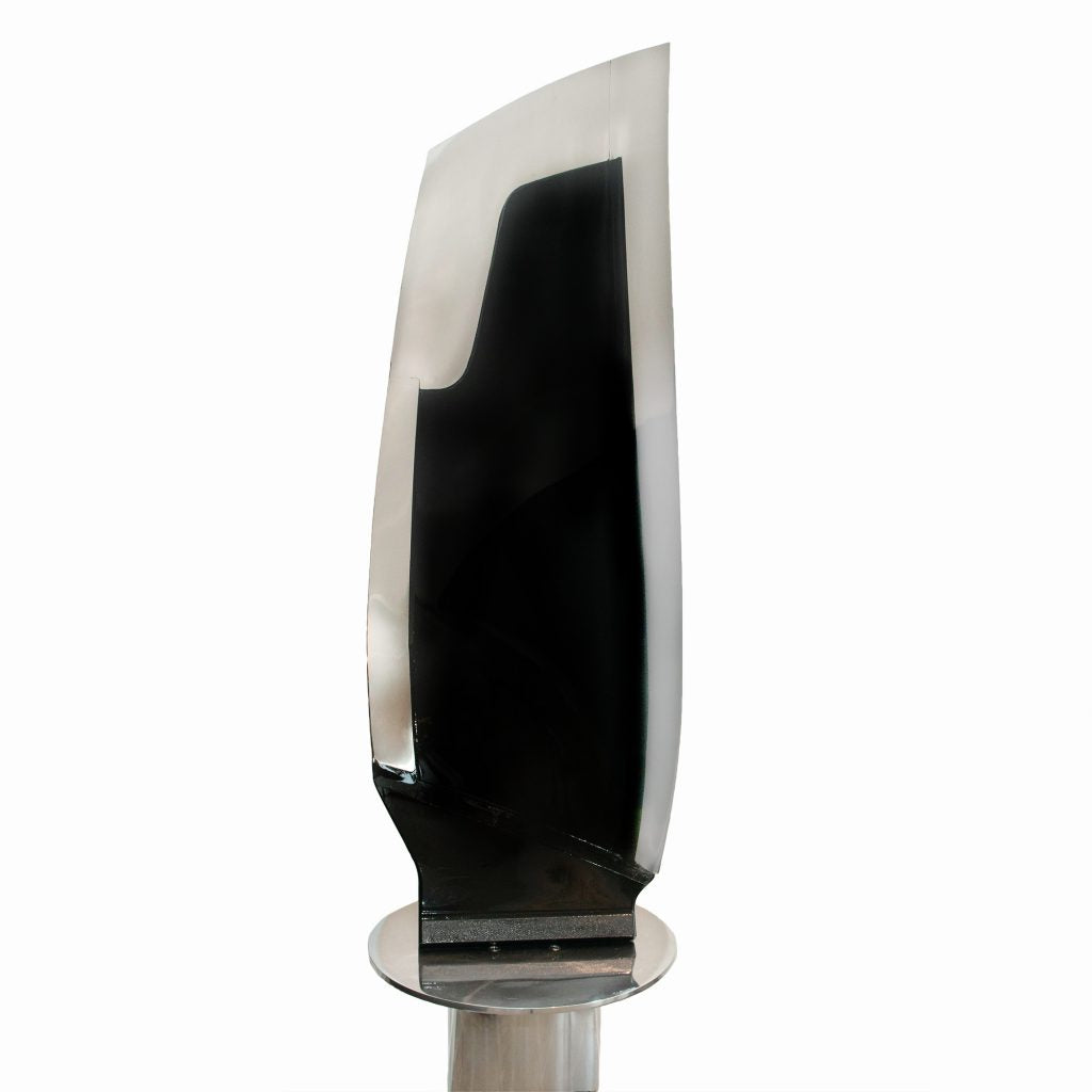 Boeing 777 General Electric GE90 jet engine blade mounted to a rotating polished base.