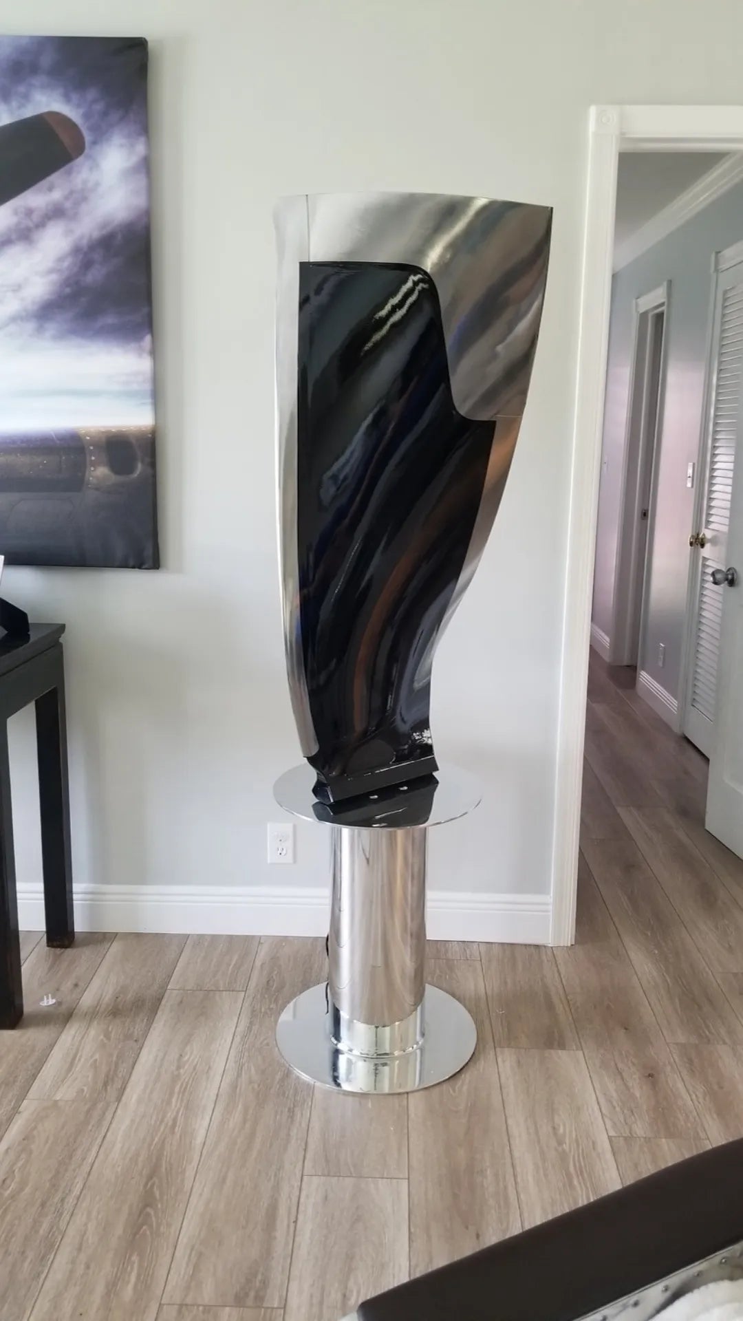 Boeing 777 General Electric GE90 jet engine blade mounted to a rotating polished base.